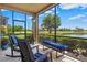 Enjoy tranquil lake views from this screened lanai with comfortable seating and rocking chairs at 23528 Awabuki Dr # 101, Venice, FL 34293
