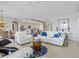 Open-concept living room flows into the kitchen and has comfortable seating arrangements at 23528 Awabuki Dr # 101, Venice, FL 34293