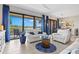 Bright living room features comfortable seating and a sliding door to the patio at 23528 Awabuki Dr # 101, Venice, FL 34293