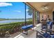 Relaxing screened patio boasts comfortable seating and serene lake views at 23528 Awabuki Dr # 101, Venice, FL 34293
