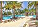 Resort-style pool with ample seating, lush palms, and inviting umbrellas provide a relaxing oasis for community members at 23528 Awabuki Dr # 101, Venice, FL 34293