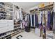 Spacious walk-in closet with custom shelving, hanging racks, and ample storage space for clothes and shoes at 23528 Awabuki Dr # 101, Venice, FL 34293