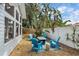 Cozy backyard featuring a fire pit seating area, lush plantings, and a charming cottage-style home at 2646 Martin St, Sarasota, FL 34237