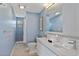Stylish blue bathroom features a double sink vanity and shower with white tile at 2646 Martin St, Sarasota, FL 34237