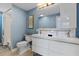 Stylish blue bathroom features a double sink vanity and shower with white tile at 2646 Martin St, Sarasota, FL 34237