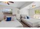 Charming bedroom showcases twin beds, ceiling fans, and bright windows at 2646 Martin St, Sarasota, FL 34237