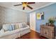 Bonus room featuring a ceiling fan, hardwood floors, and blue accent wall at 2646 Martin St, Sarasota, FL 34237