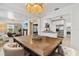 Open-concept dining area featuring wooden table with bar stools, kitchen, and living spaces at 2646 Martin St, Sarasota, FL 34237