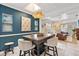 Stylish dining area featuring a large wooden table, bar stool and open layout at 2646 Martin St, Sarasota, FL 34237