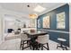 Dining area with a rustic wooden table, stylish pendant lighting, and open concept design at 2646 Martin St, Sarasota, FL 34237