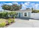 Charming home with a well-maintained front yard, fresh landscaping, a new front door, and a cozy front porch at 2646 Martin St, Sarasota, FL 34237