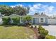 Charming home featuring a well-manicured front yard, blue door, and a welcoming garden at 2646 Martin St, Sarasota, FL 34237