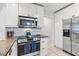 Bright kitchen featuring stainless steel appliances, granite countertops, and white cabinetry at 2646 Martin St, Sarasota, FL 34237