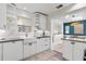 Bright white kitchen features granite countertops, farmhouse sink, and ample cabinet space at 2646 Martin St, Sarasota, FL 34237