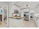 Open kitchen layout with stainless steel appliances and bar top seating at 2646 Martin St, Sarasota, FL 34237
