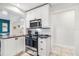 Well appointed kitchen features stainless steel appliances, granite countertops and white cabinetry at 2646 Martin St, Sarasota, FL 34237