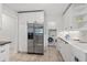 Bright kitchen featuring stainless steel refrigerator, and laundry area at 2646 Martin St, Sarasota, FL 34237