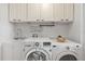 Laundry room features sink, washer, dryer and plenty of cabinet space above at 2646 Martin St, Sarasota, FL 34237