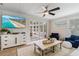 Comfortable living room with a view of the sunroom, modern ceiling fan and TV at 2646 Martin St, Sarasota, FL 34237