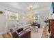 Bright living room featuring a comfortable sofa, fireplace, and natural light at 2646 Martin St, Sarasota, FL 34237