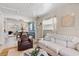 Cozy living room connected to dining area featuring tile flooring and a fireplace at 2646 Martin St, Sarasota, FL 34237