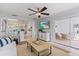 Airy living room featuring beach view TV, sunroom access and open to kitchen at 2646 Martin St, Sarasota, FL 34237