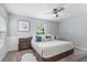 Main bedroom features wainscoting, a ceiling fan, and a large window at 2646 Martin St, Sarasota, FL 34237