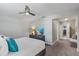 Bright main bedroom with neutral tones, ceiling fan, and large TV at 2646 Martin St, Sarasota, FL 34237