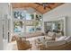 Bright sunroom featuring large windows, tile flooring, and comfortable seating arrangement at 2646 Martin St, Sarasota, FL 34237