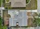 An aerial view showcases the property layout, including the house, driveway, and backyard shed at 2708 27Th Avenue W Dr, Bradenton, FL 34205