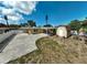Spacious backyard features a shed, mature landscaping, patio cover, and a large paved area at 2708 27Th Avenue W Dr, Bradenton, FL 34205