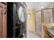 Compact bathroom with stackable washer/dryer, a tiled shower, and a vanity area at 2708 27Th Avenue W Dr, Bradenton, FL 34205