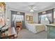 Bright bedroom with desk, bed, natural light, and neutral-colored walls at 2708 27Th Avenue W Dr, Bradenton, FL 34205