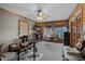 Bonus room with wood paneling, ceiling fan, seating area, and drum set at 2708 27Th Avenue W Dr, Bradenton, FL 34205