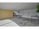 Spacious carport featuring concrete flooring, white pillars, and doors to storage at 2708 27Th Avenue W Dr, Bradenton, FL 34205