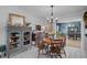 Elegant dining room featuring a round table, classic chandelier, and open access to the living area at 2708 27Th Avenue W Dr, Bradenton, FL 34205