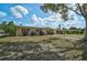 Street view of a cozy single story house with a lawn, blue skies and curb appeal at 2708 27Th Avenue W Dr, Bradenton, FL 34205