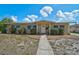 Charming single story home with a well-maintained lawn, front yard landscaping, and a inviting walkway to the front door at 2708 27Th Avenue W Dr, Bradenton, FL 34205