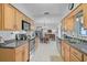 Well-lit kitchen with wooden cabinets, stainless steel appliances, and a view into the dining area at 2708 27Th Avenue W Dr, Bradenton, FL 34205