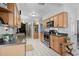 Functional kitchen with wooden cabinets, tile floors, and access to the rest of the home at 2708 27Th Avenue W Dr, Bradenton, FL 34205