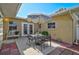 A cozy brick-lined patio with an outdoor table and chairs under a sun umbrella at 2708 27Th Avenue W Dr, Bradenton, FL 34205