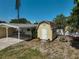 Outdoor shed with adjacent covered carport, providing extra space for storage and parking at 2708 27Th Avenue W Dr, Bradenton, FL 34205