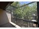 Relaxing screened-in balcony with a view of mature trees and foliage at 2729 Hidden Lake Blvd # D, Sarasota, FL 34237