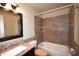 Bathroom with granite vanity and shower over tub tiled with horizontal accent tile at 2729 Hidden Lake Blvd # D, Sarasota, FL 34237