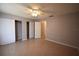 Neutral bedroom featuring tile flooring, a ceiling fan, and ample closet space at 2729 Hidden Lake Blvd # D, Sarasota, FL 34237