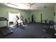 Community gym with several machines, weights, and a ceiling fan in a shared space at 2729 Hidden Lake Blvd # D, Sarasota, FL 34237