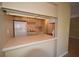 Kitchen featuring breakfast bar, white cabinets, and appliances at 2729 Hidden Lake Blvd # D, Sarasota, FL 34237