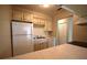 Galley kitchen with white appliances and cabinets at 2729 Hidden Lake Blvd # D, Sarasota, FL 34237