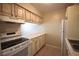 Functional kitchen with white appliances, wooden cabinets and ample counter space at 2729 Hidden Lake Blvd # D, Sarasota, FL 34237