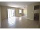 Bright living room featuring tile floors, a ceiling fan, and sliding glass doors to a balcony at 2729 Hidden Lake Blvd # D, Sarasota, FL 34237